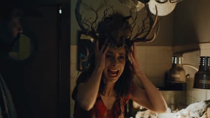 Patricia screams in her antler crown in Widow's Bay.