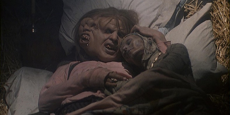 Enoch and Myrna share a hug in Tales from the Crypt's "Lower Berth"