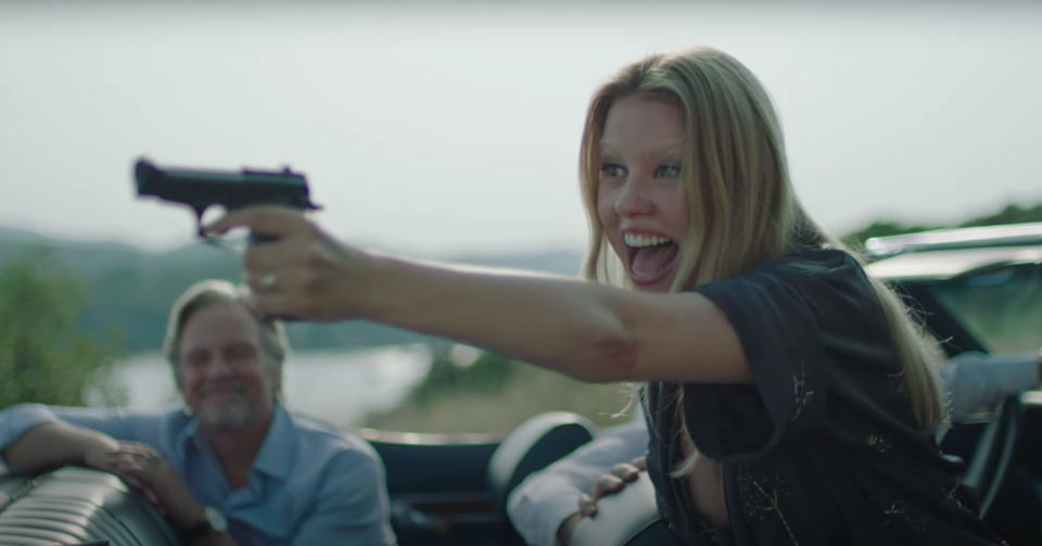 Mia Goth with a gun in Infinity Pool