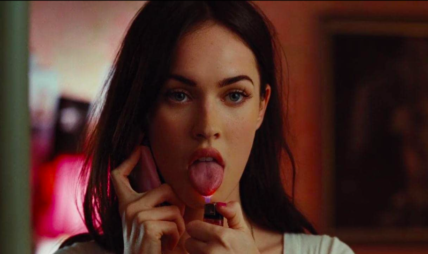 Megan Fox as Jennifer from "Jennifer's Body" holds a cellphone to her ear and holds the flame of a lighter to the tip of her tongue killer women