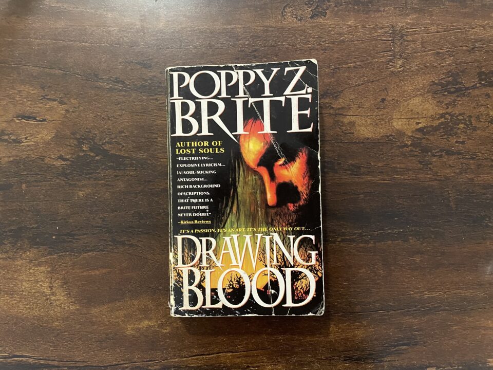 A well-loved paperback copy of Drawing Blood by Poppy Z. Brite