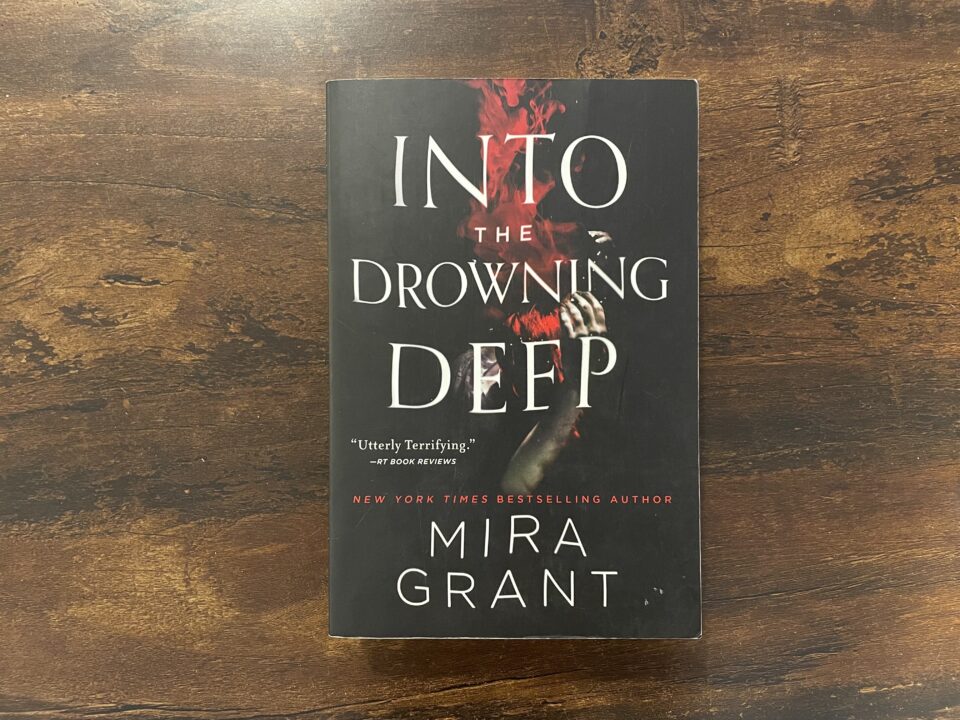 A paperback copy of Into the Drowning Deep by Mira Grant
