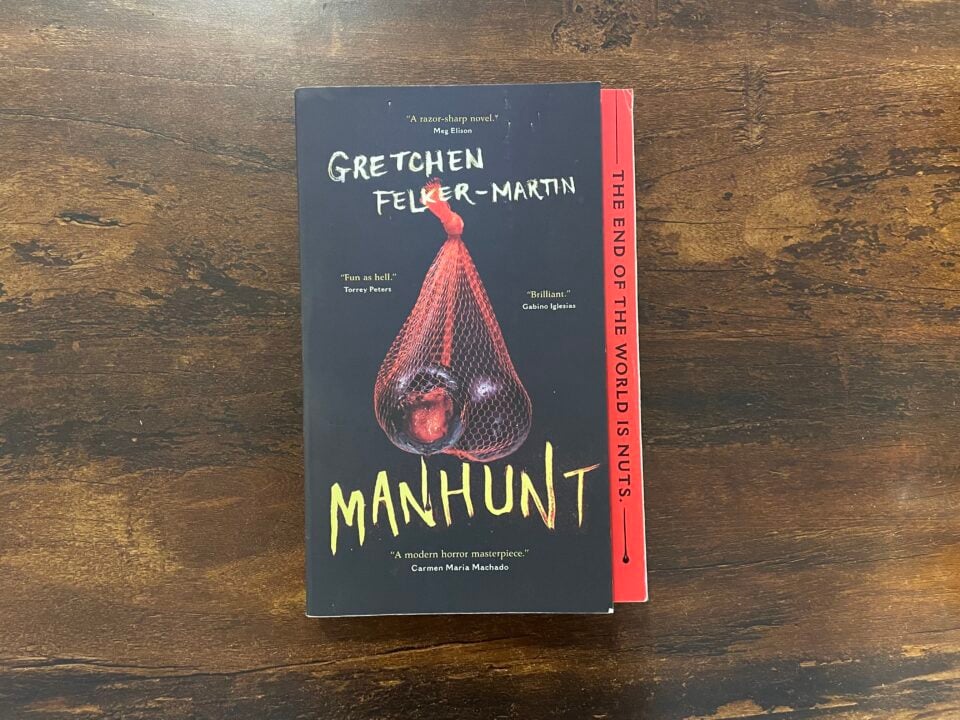 A paperback copy of the horror novel Manhunt by Gretchen Felker-Martin