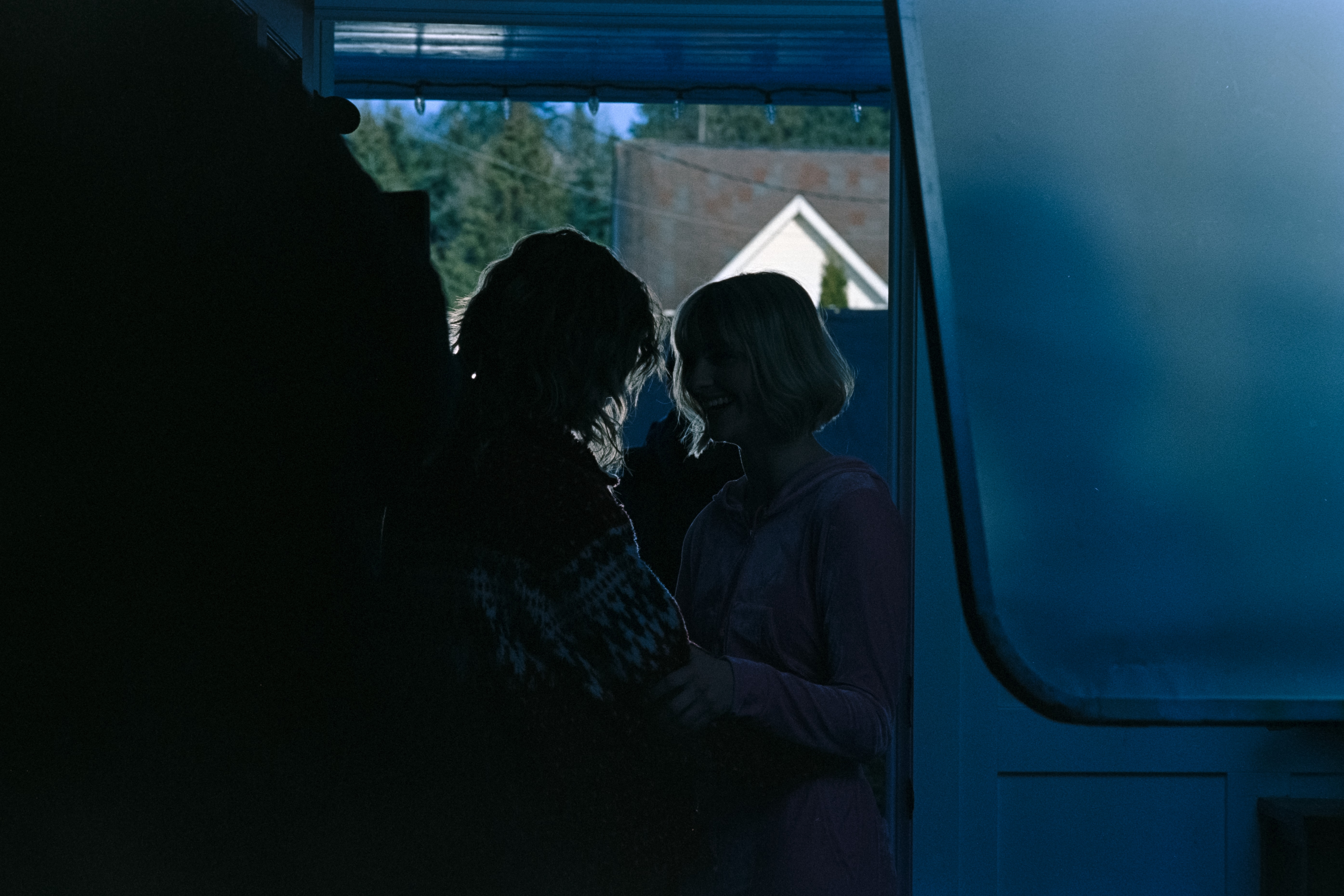 Actors Jane Widdop and Jess McCleod embrace on the set of "It's a Wonderful Knife"